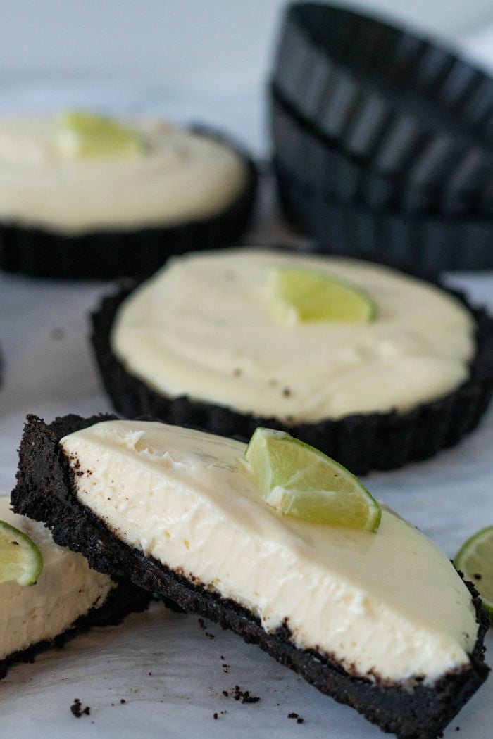 a lime tart is cut in half to show the inside of the tart